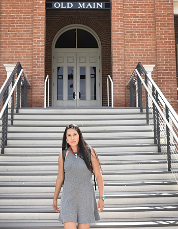 Photo of Morgan walking down Old Main stairs