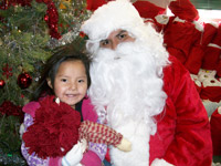 Native American child sitting on Santa's lap at Christmas