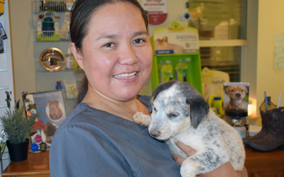 A photo of Dr. Holgate holding a puppy