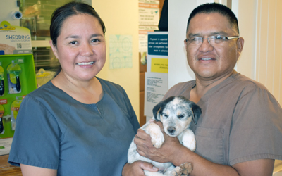 Dr. Holgate and her Husband, Elwood, holding a puppy