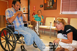 Photo of Melissa fitting Jonathon with CROCS